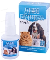 За вухами